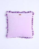 Back view of lilac velvet cushion showing smooth fabric and purple tassel border detail