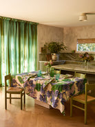 Lilas Blue Tablecloth with purple floral print covering dining table in modern kitchen setting