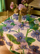 Close-up view of Lilas Blue Tablecloth showing detailed purple flowers and green leaves pattern on linen fabric