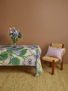 Side view of Lilas Blue Tablecloth on table showing natural fabric fall and purple botanical print