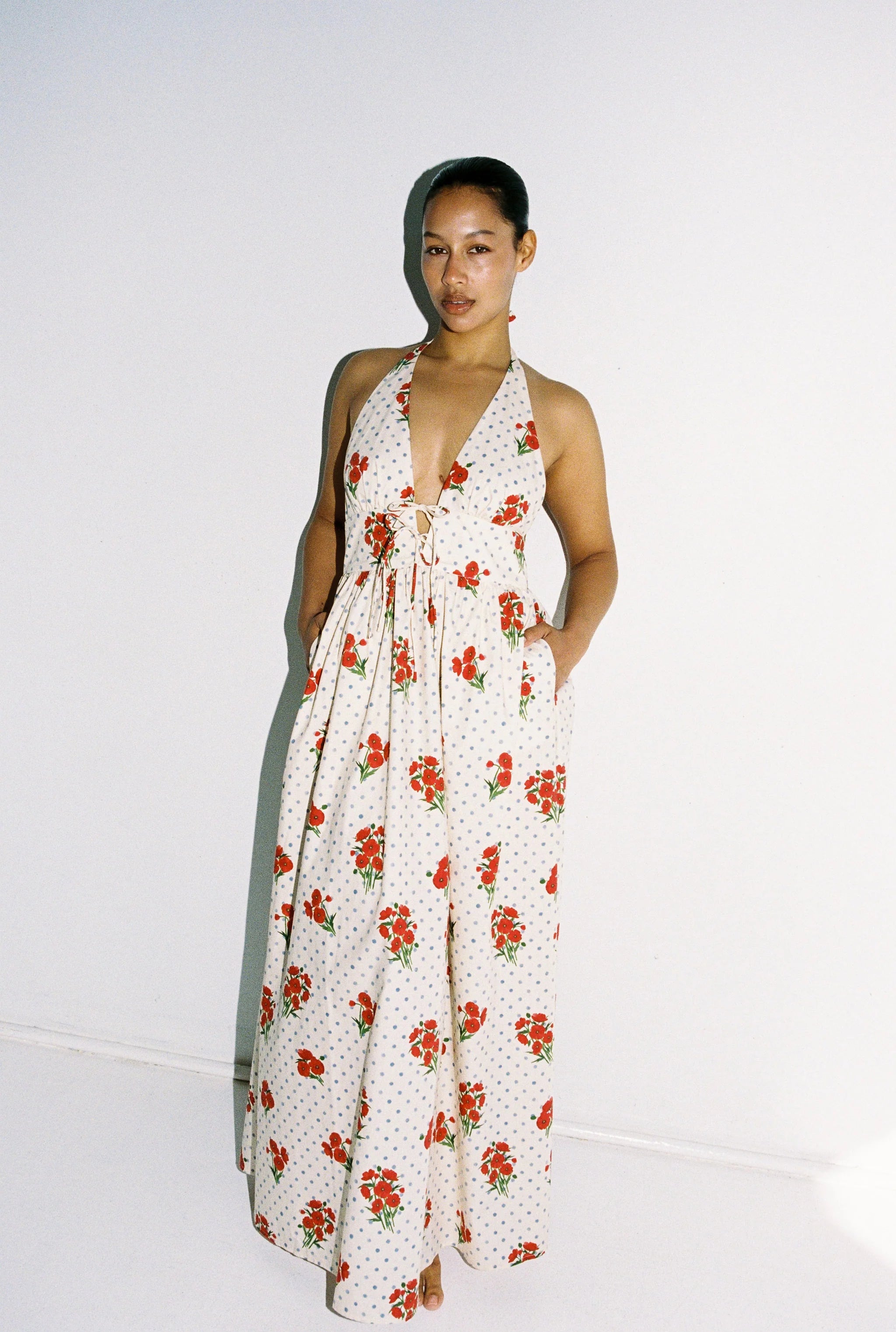 Lady wearing maxi dress with blue polka dots and red flowers - 100% cotton