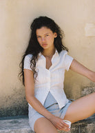 women wearing button down white cotton shirt with pintucking feacture and cap sleeves