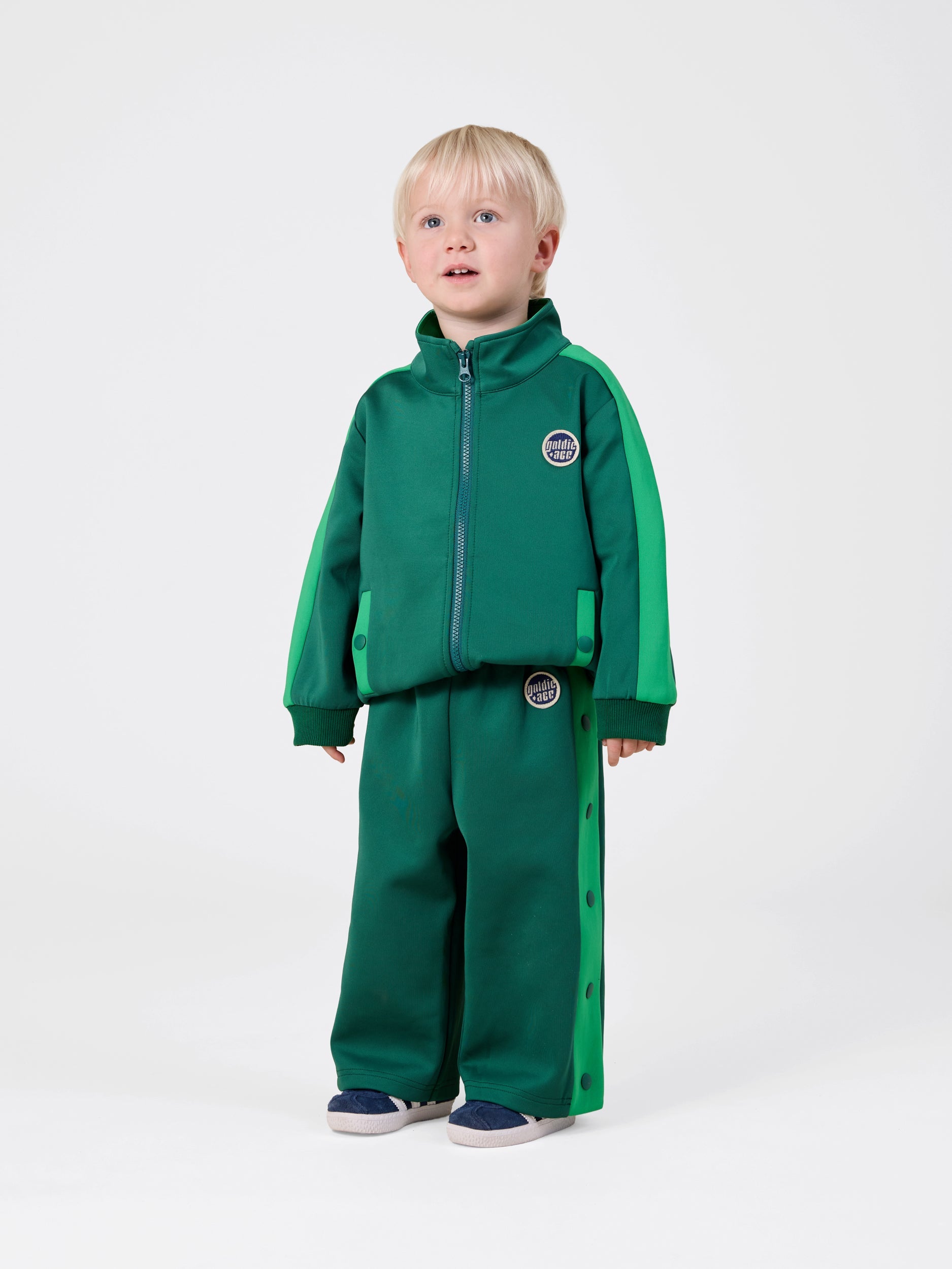 Young boy in the Logo Track Snap Pants | Goldie + Ace