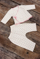 Flat lay of Lolly Set pajama pieces showing roses pattern and pink trim detailing