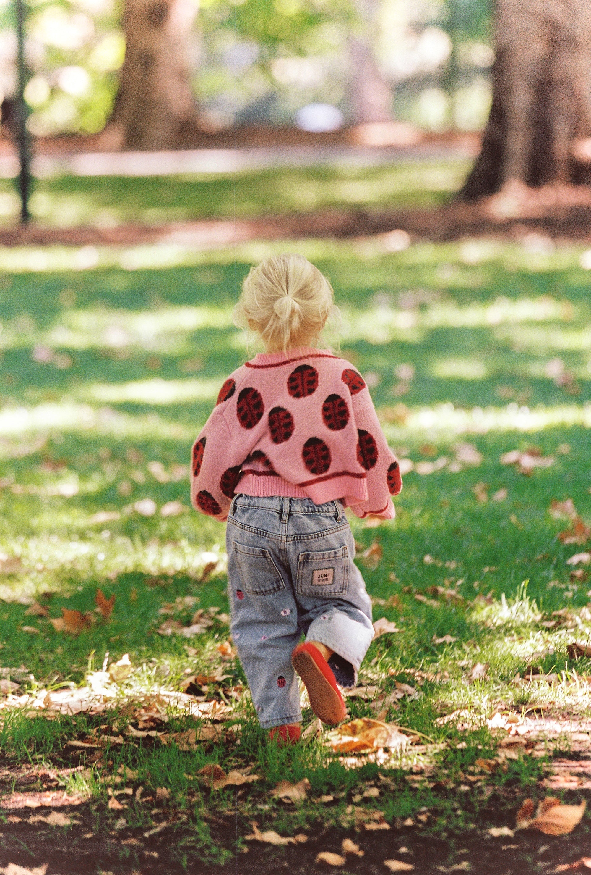 girl wearing Juni Love Bug Cardigan recycled acrylic sustainable knitwear