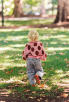 girl wearing Juni Love Bug Cardigan recycled acrylic sustainable knitwear