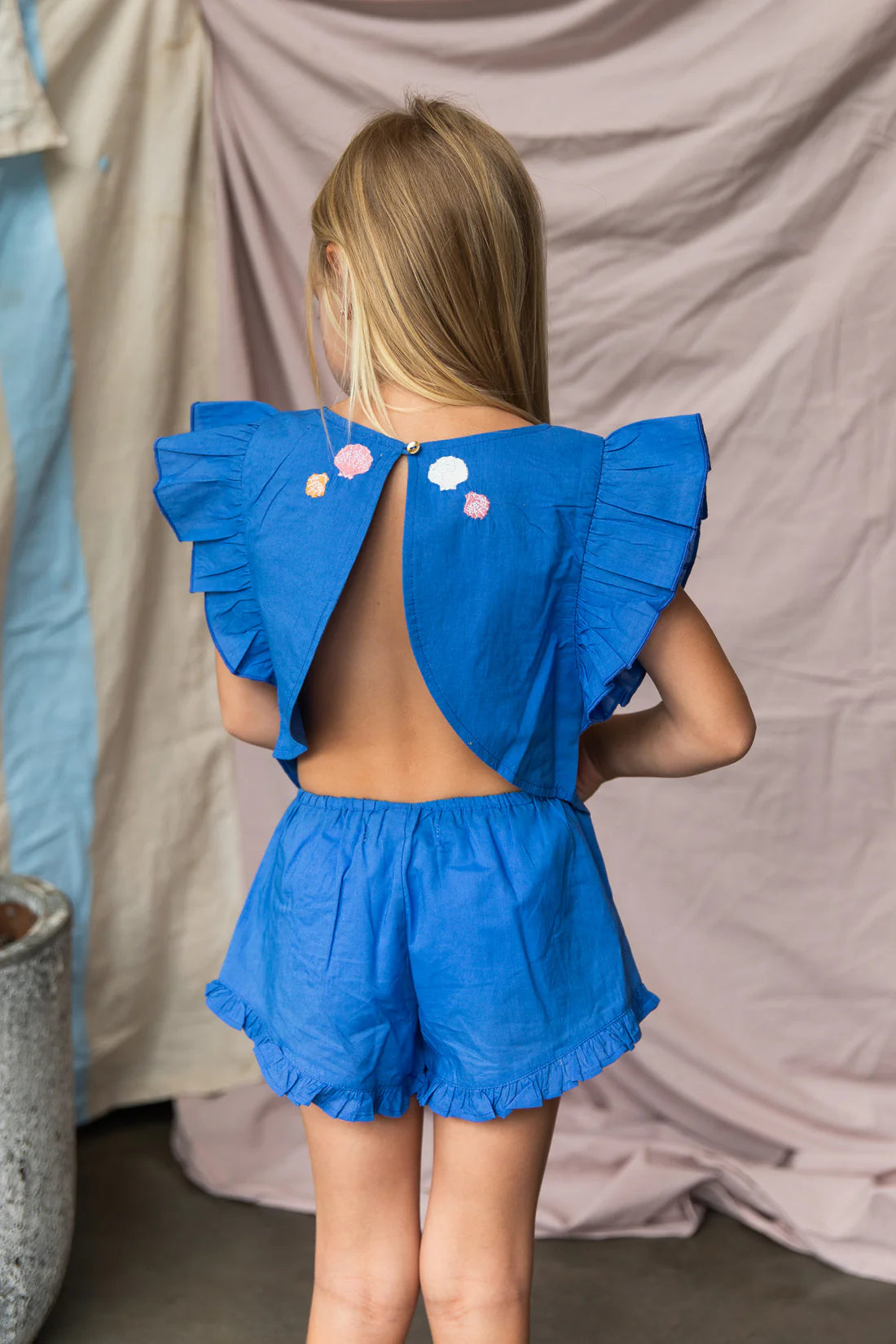 Girl wearing blue 100%cotton top with open back and coral embroidery - Lucia Top Yves Klien by Pearson and Pearson