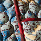 Close up detail of Lucia Double Oven Mitt by Sage & Clare - blue floral design with burgundy edges