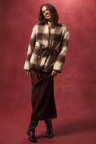 Front view of Luka Jacket showing check pattern faux fur texture with brown leather belt tie