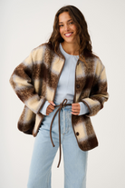 Open front styling of Luka Jacket with check pattern and brown leather tie belt details