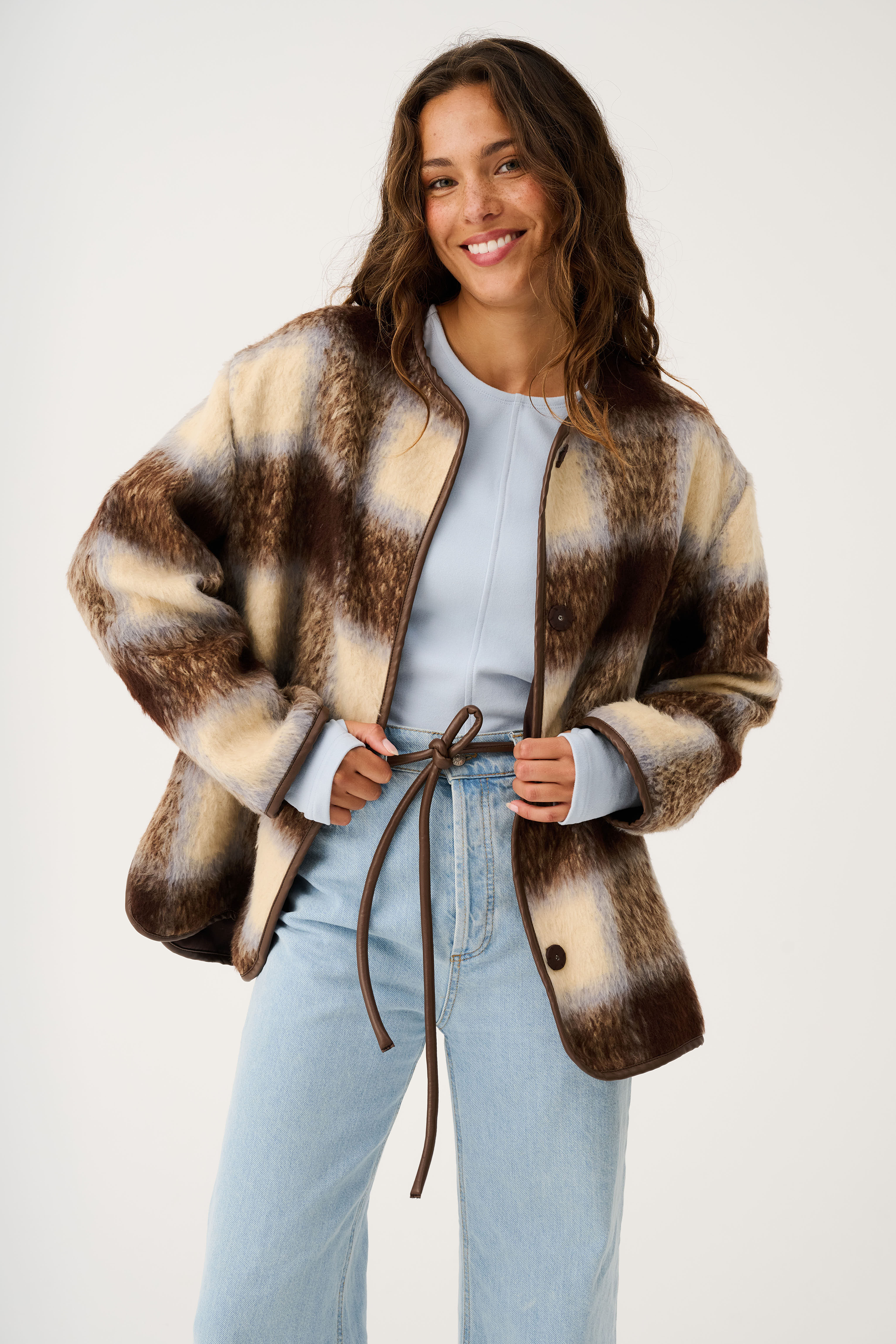 Open front styling of Luka Jacket with check pattern and brown leather tie belt details