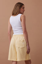 back view of model wearing Lulu reverse panel short sunny yellow by Ceres Life