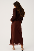 Back view of Luna Skirt in truffle brown showing midi length silhouette and delicate lace hem detail