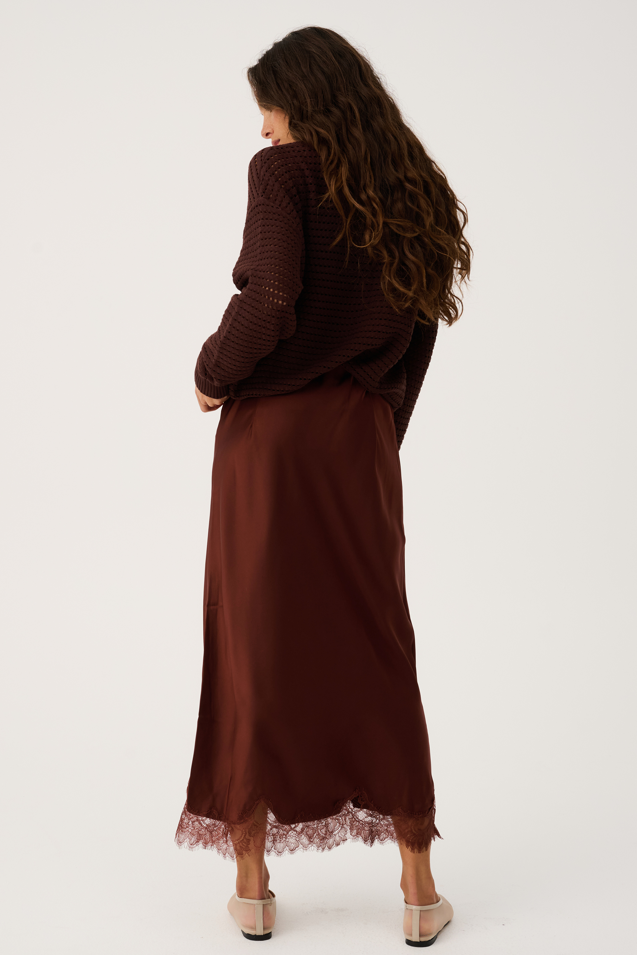 Back view of Luna Skirt in truffle brown showing midi length silhouette and delicate lace hem detail