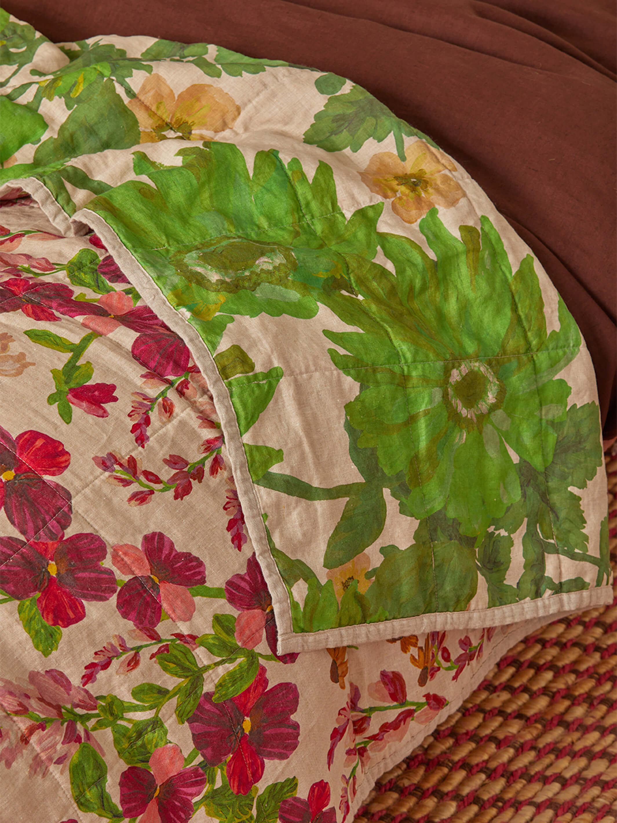 Close-up of Lupin Multi quilted throw showing large green leaf pattern and quilted linen texture detail