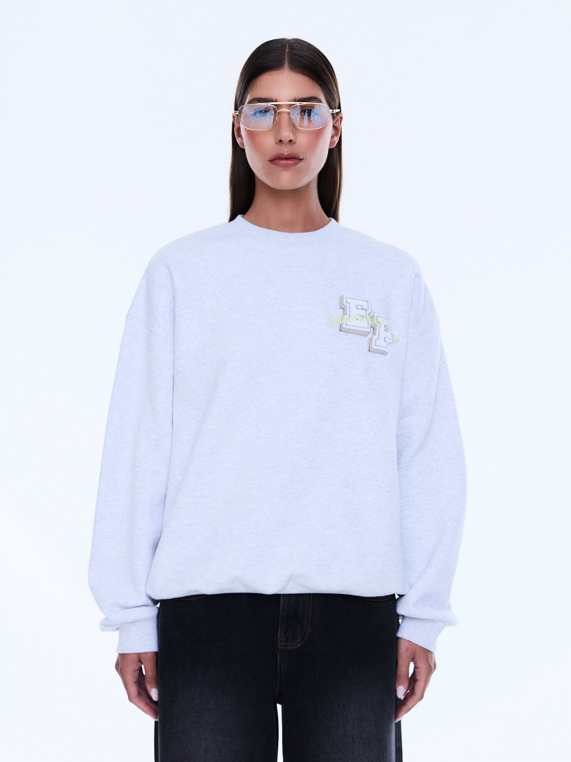 Front view of white Mila Oversized Sweater with embroidered logo and crew neckline