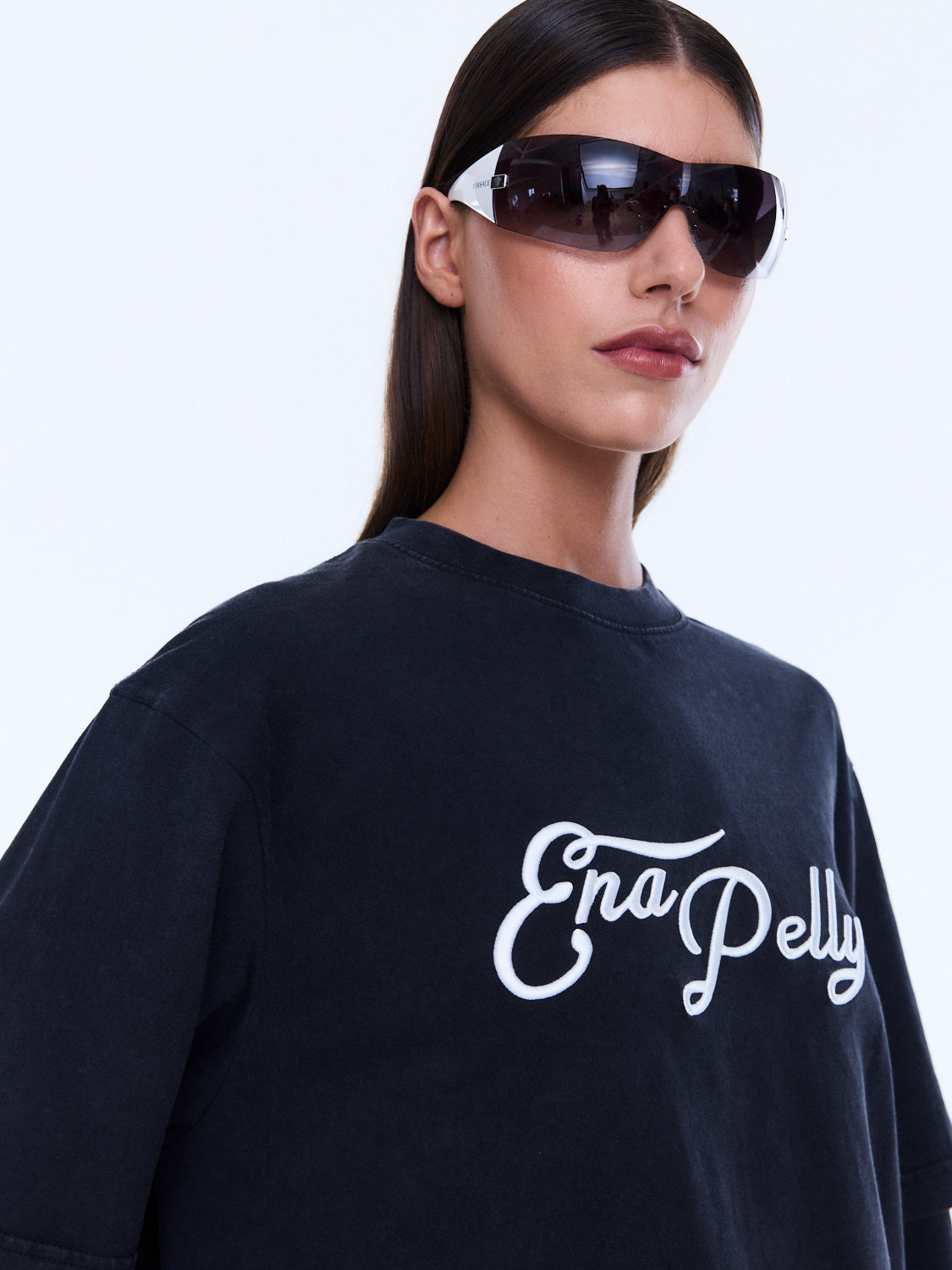 Close-up detail of Mock Layer Long Sleeve Tee showing white script logo on vintage black fabric