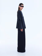 Side profile view of Mock Layer Long Sleeve Tee displaying layered sleeve detail and oversized fit