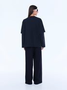 Back view of Mock Layer Long Sleeve Tee showing plain vintage black rear design and layered construction