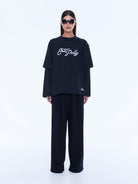 Full front view of Mock Layer Long Sleeve Tee in vintage black with white logo and layered sleeves