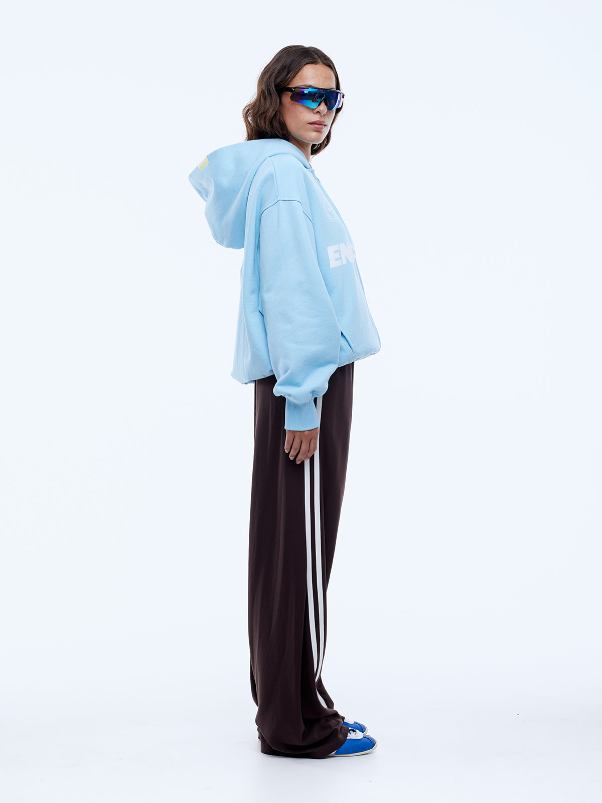 Side profile view of cloud blue zip hoodie showing relaxed silhouette and hood shape