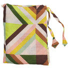 Linen pillowcase set stored in a matching geometric print drawstring storage bag