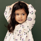 Young girl wearing the Mabel Dress - Winter Berry Natural Print | Nature Baby