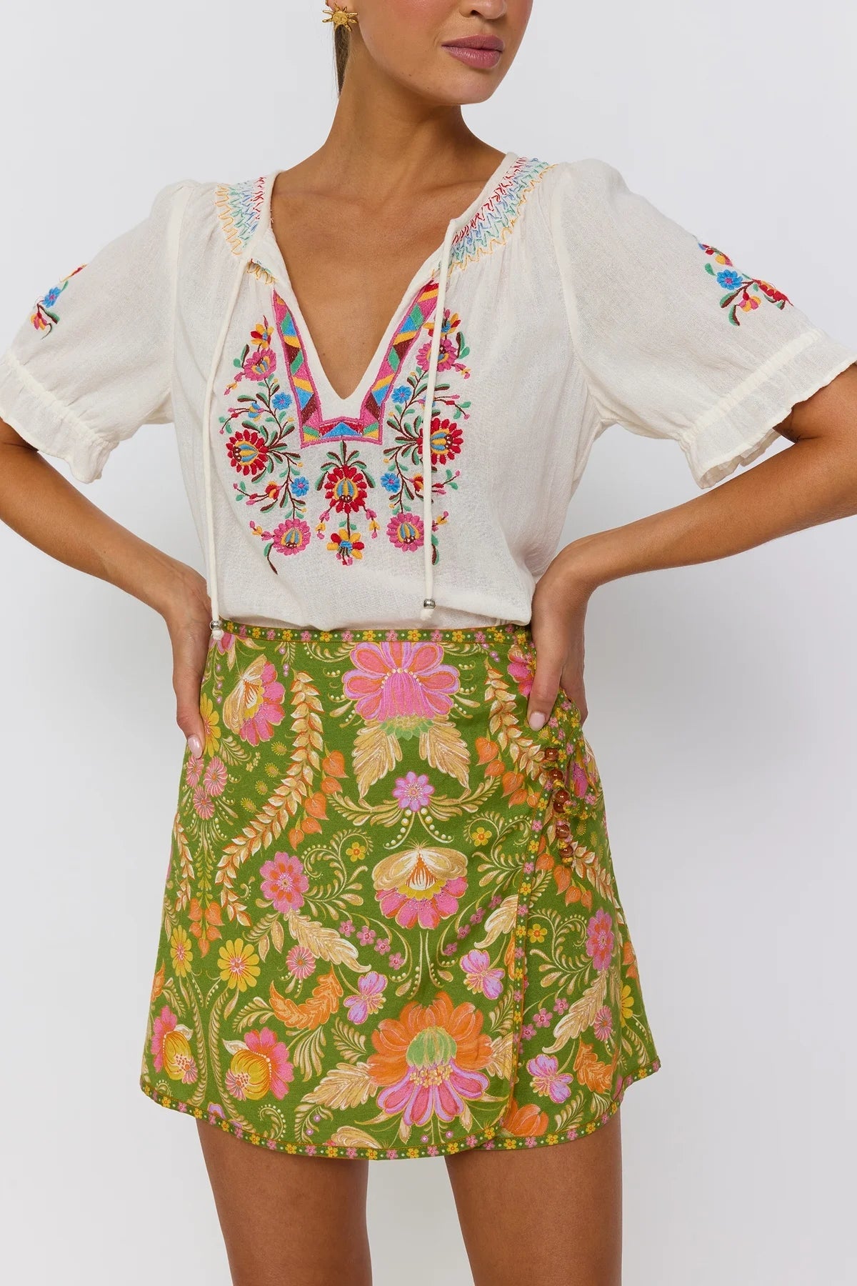 Guava mini skirt A-line wrap silhouette with lace-up hip detail Nine Lives Bazaar