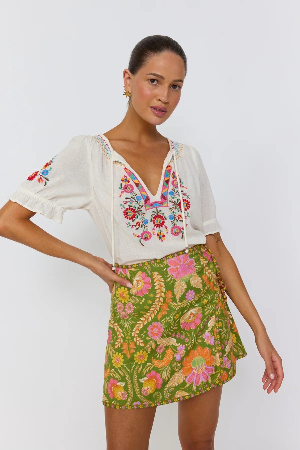 Close up lace-up hip accent with resin beads on Maison mini skirt guava print
