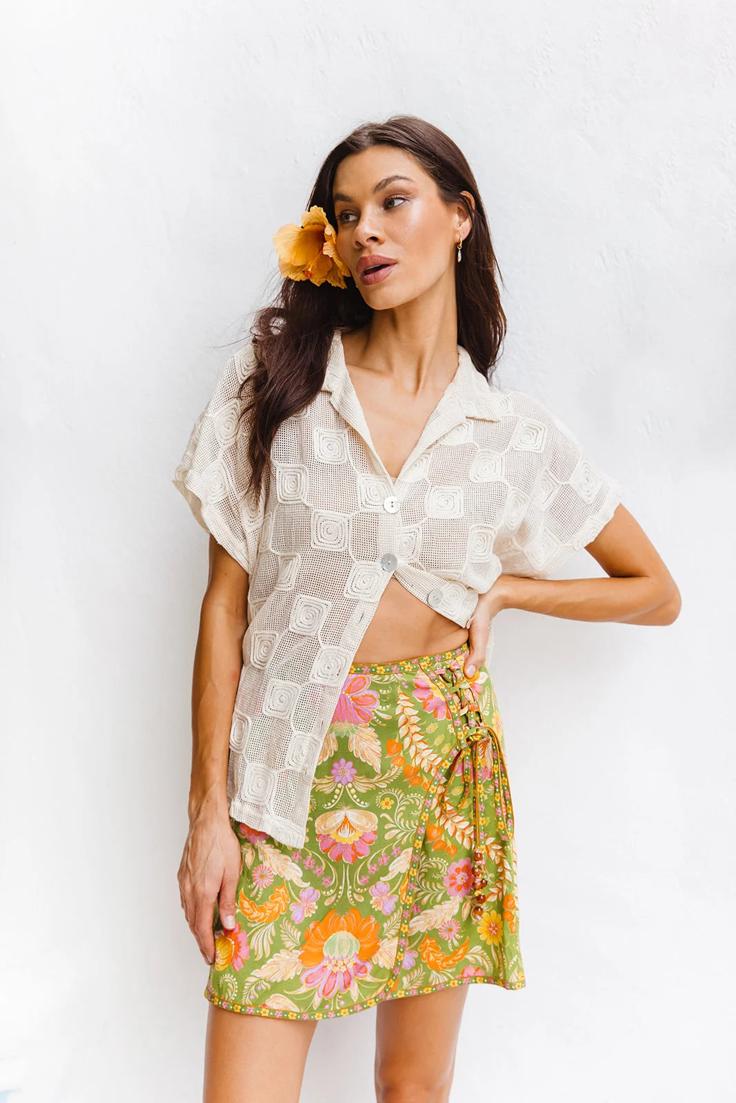 Woman wearing Maison mini skirt guava styled with simple white tee casual look