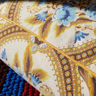 edge details of Margaret Floor Cushion – Clay by Sage & Clare with yellow and blue flowers