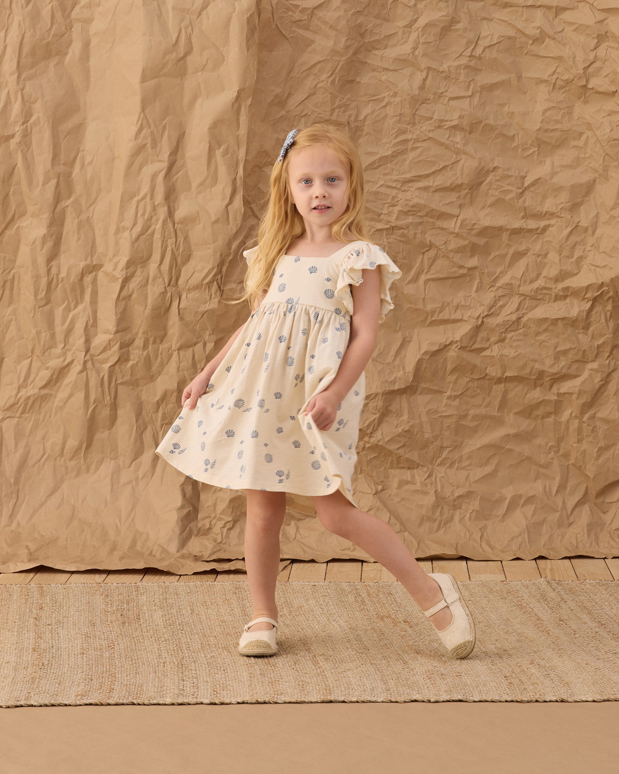 Young girl in the Mariposa Seashell Dress | Rylee + Cru