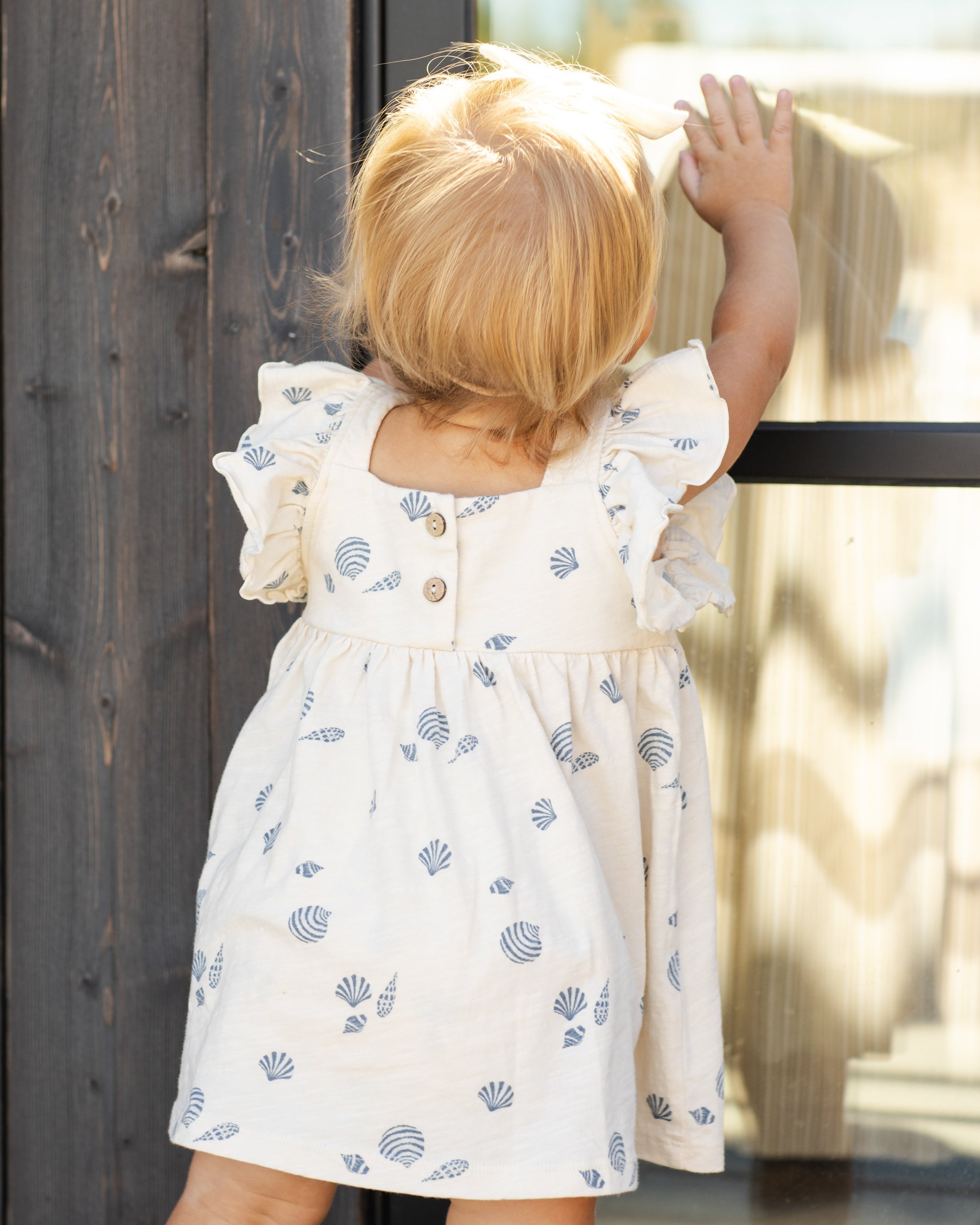 Back view of girl wearing Mariposa Seashell Dress | Rylee + Cru