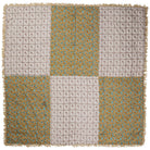 Reverse side of velvet bedcover laid flat, showing patchwork panels of cream grid floral and teal gold ditsy floral print with fringe trim