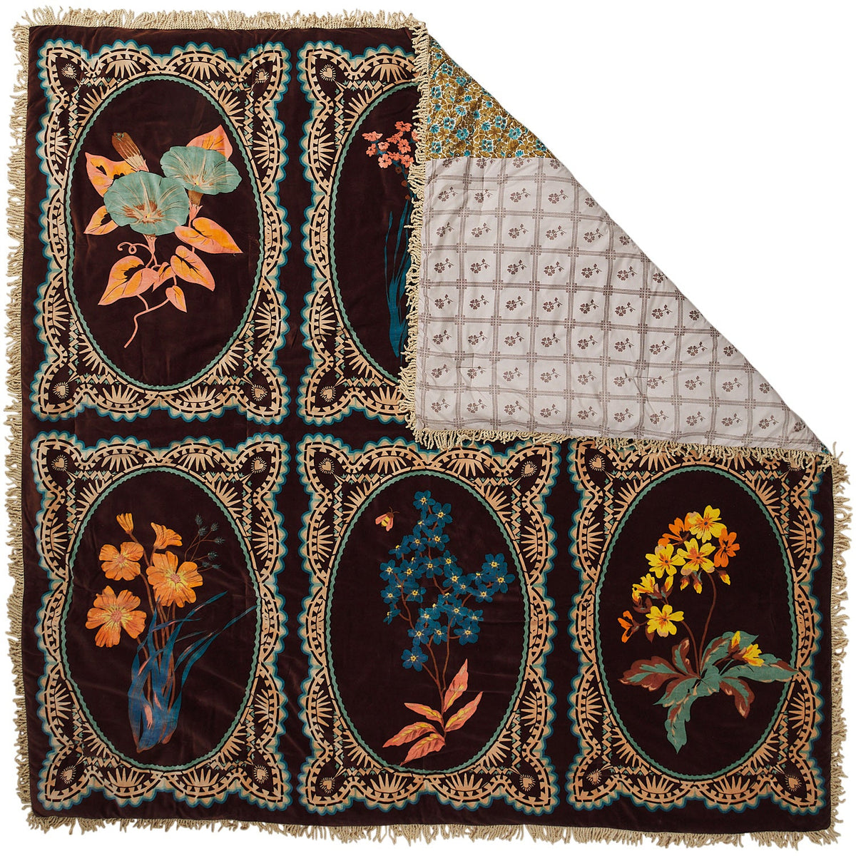 Brown velvet bedcover laid flat with corner folded back to reveal patchwork floral reverse lining and cream fringe trim