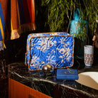 Ultramarine blue quilted vanity bag with wide zip opening for beauty essentials organization