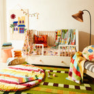 Wool wall hanging with colourful houses, palm tress and sun.