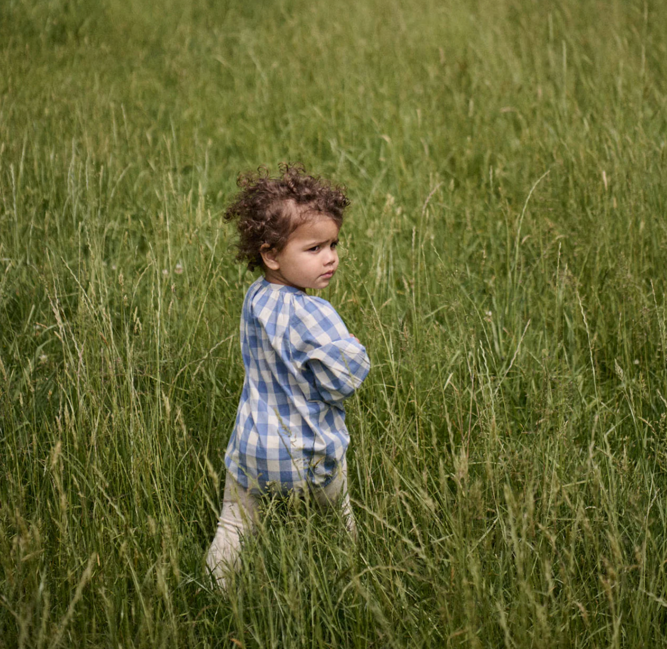 Back view of young child in the Meadow Bodysuit Gingham - Bluebelle Check | Nature Baby