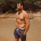man wearing Swim shorts sapphire sand by Swim Shady with navy geometric print
