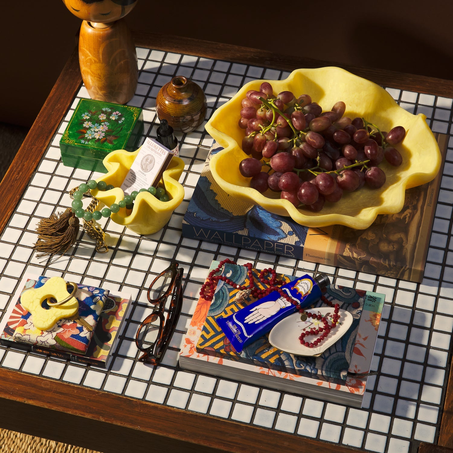 Aspen Gold Milly Bowl styled with grapes on checkered surface with books and accessories