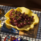 Close-up of Aspen Gold Milly Bowl filled with red grapes showing curved ruffled edges