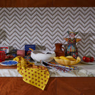 Milly Bowl in Aspen Gold on kitchen counter with colorful napkins and ceramic accessories