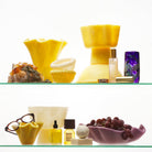 Orchid bowl with red grapes on checkered surface with dramatic brown background lighting