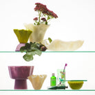 Pearl ceramic decorative bowl displayed on wooden credenza in modern living room setting