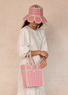 lady wearing Island Manhattan Hat – Mintberry by Lorna Murray and holding mintberry bag