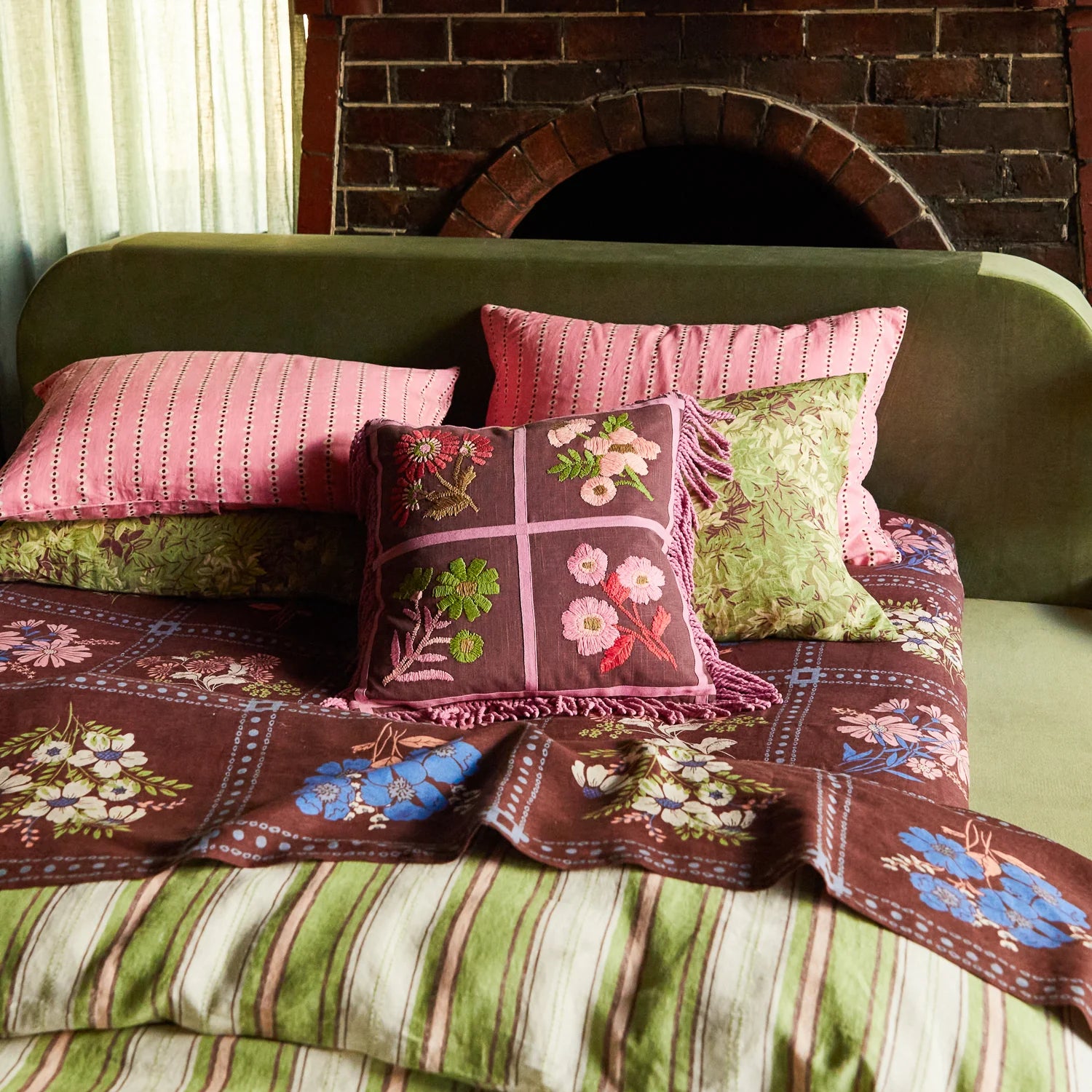 Mira Embroidered Cushion Clove by Sage & Clare displayed on bed