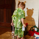 child wearing green Naia Kids Resort Set by Sage & Clare