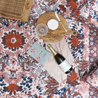 Lifestyle shot of the Native Blossom picnic Rug by Wandering Folk