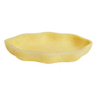 Nicole Serving Dish in Aspen Gold — low shallow bowl with irregular wavy rim and mottled resin texture, side view