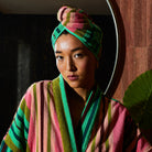 Woman wearing Sage & Clare Nicolette hair wrap in juniper green after shower
